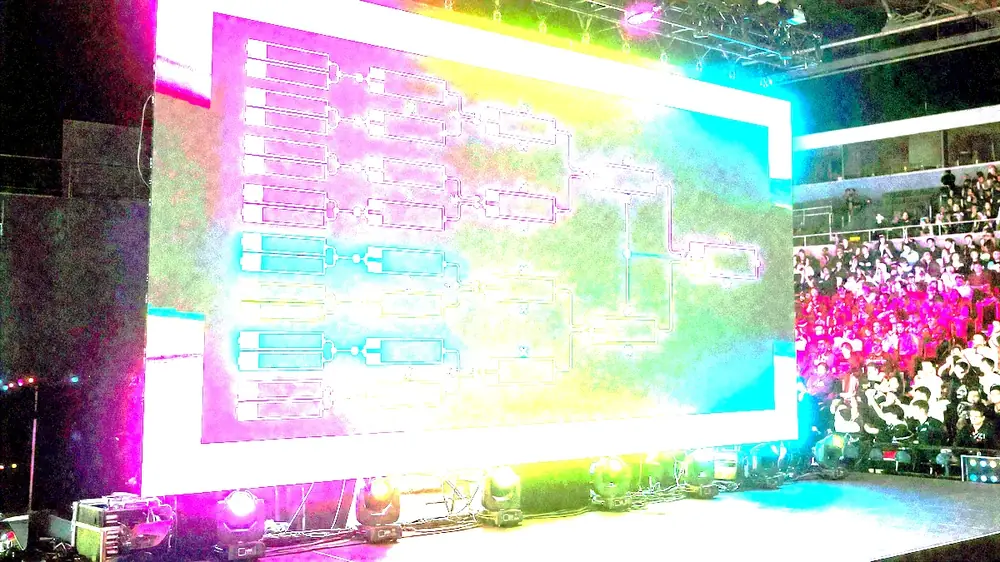 Editorial photograph of esports players focused on monitors during a Spectre match